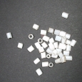 A small bag of milky white old bugle beads.
