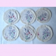 A set of six pretty vintage mats with floral centre and frilled edging. > A set of six pretty vintage mats with floral centre and frilled edging.